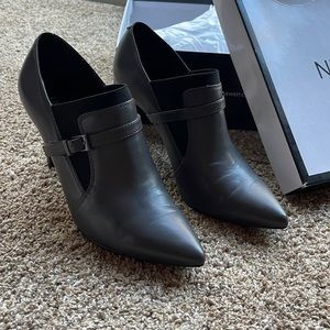 Pointed-toe heeled ankle booties.